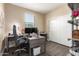 Bright home office features a large desk, office chair, and storage space at 22495 E Silver Creek Ln, Queen Creek, AZ 85142
