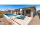 Inviting backyard oasis with a refreshing pool, stylish lounge chairs, and a covered patio area at 22495 E Silver Creek Ln, Queen Creek, AZ 85142