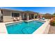 Beautiful backyard with a sparkling pool and comfortable patio area, perfect for outdoor entertaining at 22495 E Silver Creek Ln, Queen Creek, AZ 85142