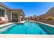 Gorgeous backyard oasis with a refreshing pool, covered patio, and well-maintained landscaping at 22495 E Silver Creek Ln, Queen Creek, AZ 85142