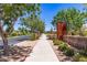 Scenic street view of Meridian community with lush trees, landscaping, and a well-maintained sidewalk at 22495 E Silver Creek Ln, Queen Creek, AZ 85142