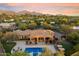 Aerial view of home with pool, spa, firepit, and patio surrounded by lush desert landscaping at 22610 N 80Th Pl, Scottsdale, AZ 85255