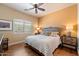 Comfortable bedroom features a ceiling fan, stylish furnishings, and a window with plantation shutters at 22610 N 80Th Pl, Scottsdale, AZ 85255