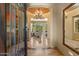 Elegant foyer featuring tile floors, chandelier, and arched doorway at 22610 N 80Th Pl, Scottsdale, AZ 85255