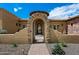Stunning arched entryway with stone accents and decorative iron gate at 22610 N 80Th Pl, Scottsdale, AZ 85255