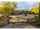 Beautiful home with a circular driveway, desert landscaping, and wrought iron gated entrance at 22610 N 80Th Pl, Scottsdale, AZ 85255