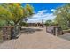 Beautiful home with a circular driveway, desert landscaping, and gated entrance at 22610 N 80Th Pl, Scottsdale, AZ 85255