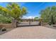 Beautiful home with a circular driveway, desert landscaping, and wrought iron gated entrance at 22610 N 80Th Pl, Scottsdale, AZ 85255