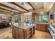 Spacious open kitchen featuring a large island, wooden beams, and stainless steel appliances at 22610 N 80Th Pl, Scottsdale, AZ 85255