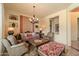 Comfortable living room with a large window, chandelier, and stylish furnishings at 22610 N 80Th Pl, Scottsdale, AZ 85255