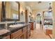 Beautiful main bathroom with dual vanities, dark granite countertops, and stylish fixtures, offering a touch of luxury at 22610 N 80Th Pl, Scottsdale, AZ 85255