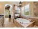 Elegant main bathroom boasts a soaking tub, fireplace, and a view, creating a relaxing and inviting atmosphere at 22610 N 80Th Pl, Scottsdale, AZ 85255