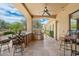 Covered outdoor kitchen with BBQ, bar seating, and travertine tile is perfect for entertainment and relaxation at 22610 N 80Th Pl, Scottsdale, AZ 85255
