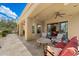 An inviting covered patio area with stylish seating and a clear view of the manicured backyard at 22610 N 80Th Pl, Scottsdale, AZ 85255