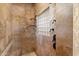 Modern tiled shower with a rain shower head and glass block window, providing a contemporary and refreshing experience at 22610 N 80Th Pl, Scottsdale, AZ 85255