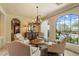 Elegant sitting area with chandelier, neutral furniture, and large window overlooking the pool at 22610 N 80Th Pl, Scottsdale, AZ 85255