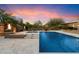 Swimming pool and spa featuring fountains, in a backyard oasis with fire bowls and lush greenery at 22610 N 80Th Pl, Scottsdale, AZ 85255