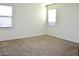 Clean, empty bedroom with neutral carpet and large windows for natural light at 2745 W Jessica Ln, Phoenix, AZ 85041
