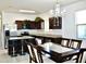 Spacious open kitchen with granite island flows into dining area under elegant chandelier at 2745 W Jessica Ln, Phoenix, AZ 85041