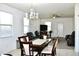 Open-concept living and dining area, chandelier, and comfortable leather furniture at 2745 W Jessica Ln, Phoenix, AZ 85041