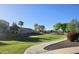 Scenic community view with lush green spaces, mature trees, and clear blue skies at 2745 W Jessica Ln, Phoenix, AZ 85041