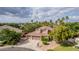 Scenic aerial view features a two-story home with desert landscaping, mature trees, and palm trees around at 30 W Sheffield Ave, Gilbert, AZ 85233