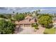 Aerial view of a property with a two-story home, three-car garage, and mature trees on a sunny day at 30 W Sheffield Ave, Gilbert, AZ 85233