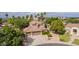 Scenic aerial shot highlights a two-story home with a three-car garage, mature landscaping, and palm trees around at 30 W Sheffield Ave, Gilbert, AZ 85233