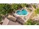 Aerial view shows a backyard with a custom pool, stone features, and patio area surrounded by lush landscaping at 30 W Sheffield Ave, Gilbert, AZ 85233