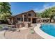 Outdoor kitchen and pool with inviting seating and dining in a well-maintained backyard space at 30 W Sheffield Ave, Gilbert, AZ 85233
