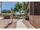 Pathway leading to the backyard amenities, featuring a play area and outdoor cooking and dining space at 30 W Sheffield Ave, Gilbert, AZ 85233