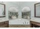 Bathroom tub with views from the window and dual vanities are featured at 30 W Sheffield Ave, Gilbert, AZ 85233