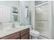 Bright bathroom with a walk-in shower, vanity with large mirror, and neutral walls at 30 W Sheffield Ave, Gilbert, AZ 85233