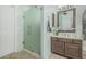 Well-lit bathroom features a glass enclosed shower, single vanity, and tiled floors at 30 W Sheffield Ave, Gilbert, AZ 85233