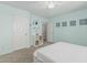 A simple bedroom with a platform bed, shelves, closet and a ceiling fan at 30 W Sheffield Ave, Gilbert, AZ 85233