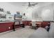 Well-lit bedroom featuring custom shelves, desk space, and modern ceiling fan at 30 W Sheffield Ave, Gilbert, AZ 85233