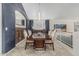 Formal dining room featuring a modern light fixture and wood-paneled accent wall at 30 W Sheffield Ave, Gilbert, AZ 85233