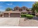 Attractive two-story home featuring a large three-car garage, concrete driveway, and well-manicured shrubs at 30 W Sheffield Ave, Gilbert, AZ 85233