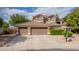 Charming two-story home featuring a three-car garage, desert landscaping, and mature trees in front at 30 W Sheffield Ave, Gilbert, AZ 85233