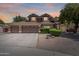 Beautiful two-story home features a three-car garage and a well-manicured front yard with mature landscaping at 30 W Sheffield Ave, Gilbert, AZ 85233