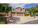Inviting two-story home with a three-car garage, desert landscaping, mature trees and for sale sign at 30 W Sheffield Ave, Gilbert, AZ 85233
