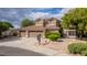Attractive two-story home with a three-car garage, desert landscaping, and mature trees at 30 W Sheffield Ave, Gilbert, AZ 85233