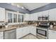 Bright kitchen with stainless steel appliances, stylish countertops, and crisp white cabinetry at 30 W Sheffield Ave, Gilbert, AZ 85233