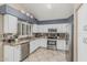 Well-lit kitchen with stainless steel appliances, granite countertops, and white cabinets at 30 W Sheffield Ave, Gilbert, AZ 85233