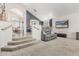 Bright living room featuring stairs, carpet, couch and open concept floorplan at 30 W Sheffield Ave, Gilbert, AZ 85233