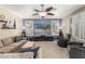 Spacious living room with plush furniture, neutral tones, and a modern ceiling fan with light at 30 W Sheffield Ave, Gilbert, AZ 85233
