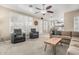 Cozy living room featuring comfortable seating, neutral carpet, and ample natural light from the large windows at 30 W Sheffield Ave, Gilbert, AZ 85233
