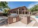 Backyard featuring a built-in outdoor kitchen with a stainless steel grill, perfect for entertaining at 30 W Sheffield Ave, Gilbert, AZ 85233