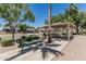 A park featuring a covered picnic area, a bench, and mature trees, creating a relaxing outdoor space at 30 W Sheffield Ave, Gilbert, AZ 85233
