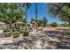A playground with a covered picnic area, slides, and swings, surrounded by lush greenery and shade at 30 W Sheffield Ave, Gilbert, AZ 85233